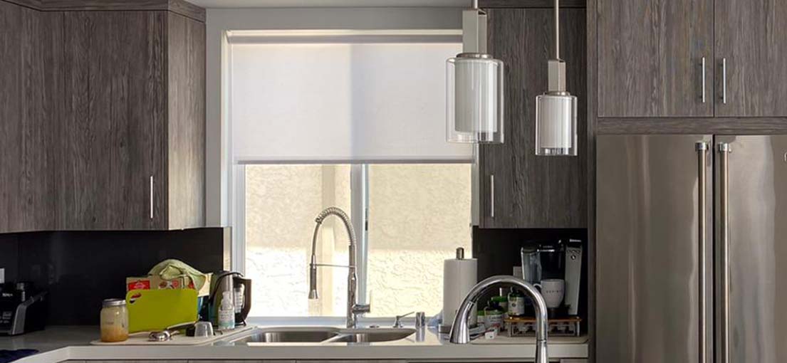A close view at a kitchen window roller shades