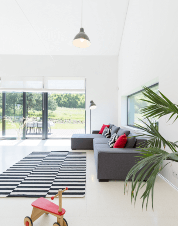 Light-filled playroom with colorful roll-up shades. The shades are partially rolled up, allowing sunlight to stream in and illuminate the playful space.