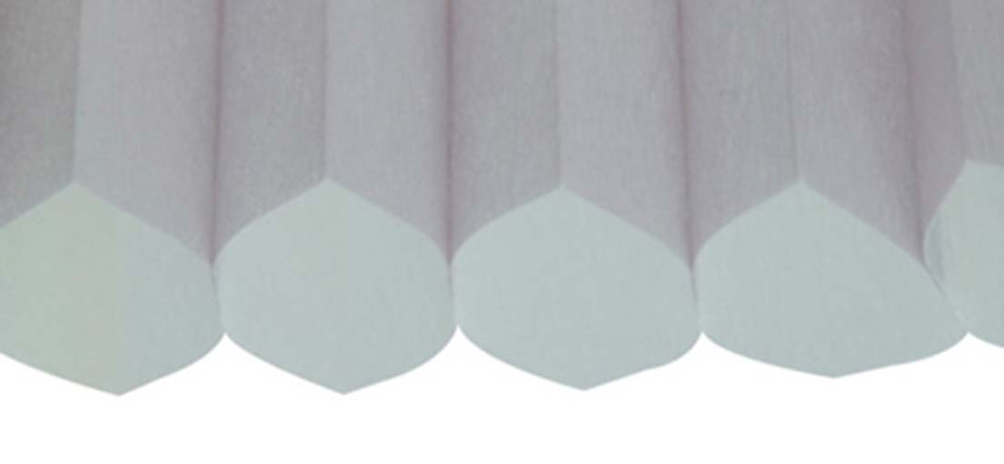 Close-up view of cellular shades with a textured finish, installed in a Somis window.