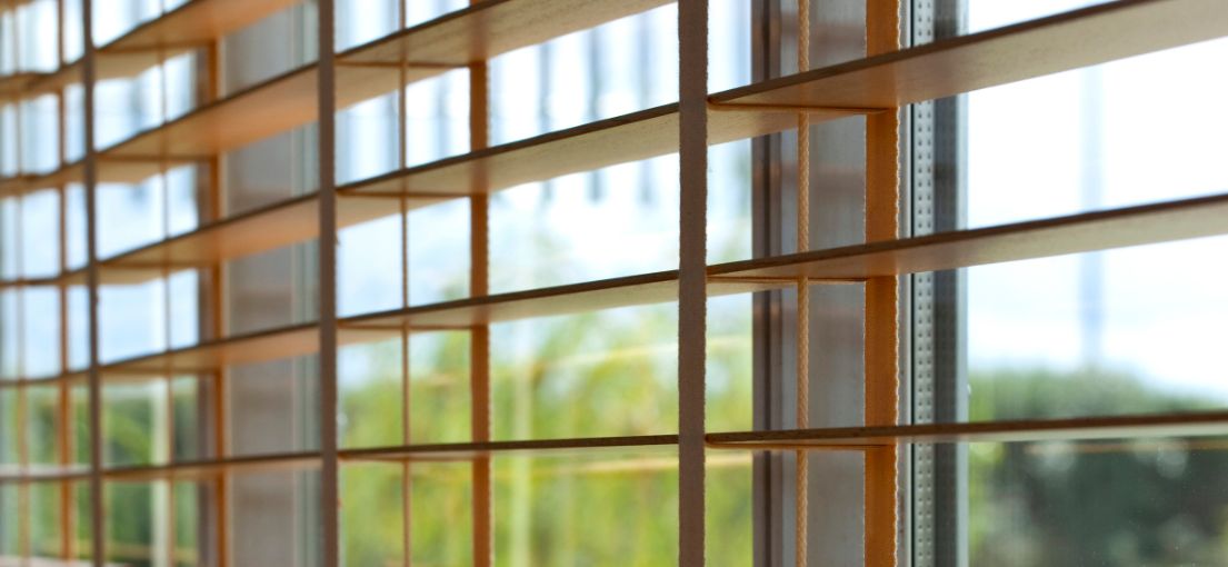 Elegant faux wood blinds with a smooth finish provide classic style and light control.