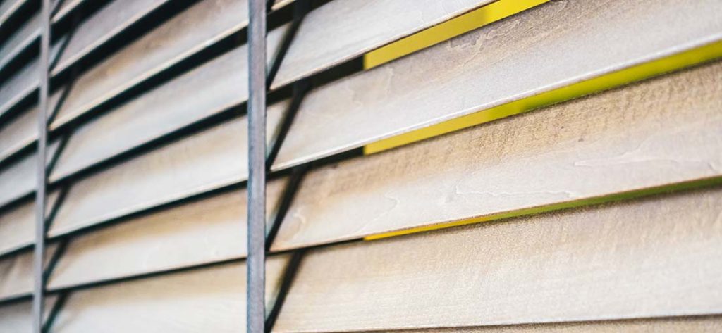 Close-up of Venetian blinds with wide slats, offering excellent light control for an Alhambra office.