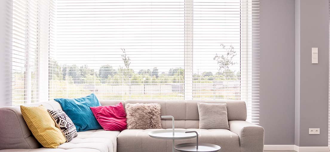 Aluminum Venetian blinds reflecting the natural light of the desert landscape in a Kinneloa Mesa home.