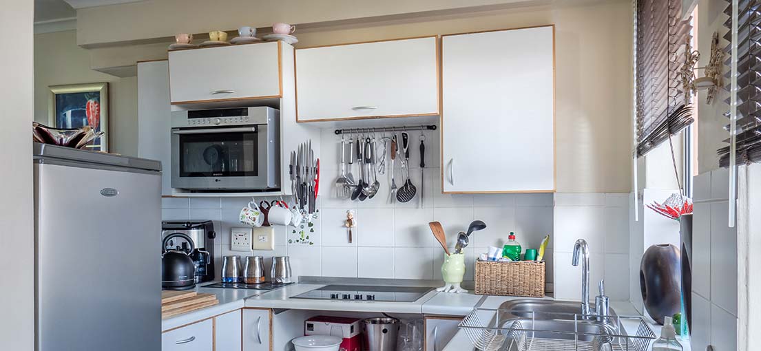 Venetian blinds offering privacy and light control in a Sherman Oaks kitchen.