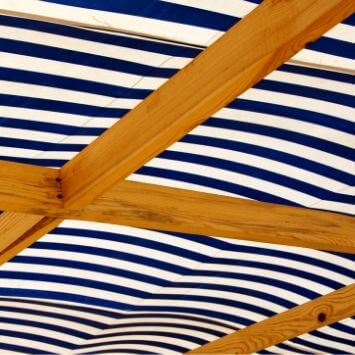 Maximize your patio's potential with an overhead canopy deck solution, offering shelter and creating a cozy atmosphere