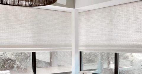 A view to a window covered with woven wood shades