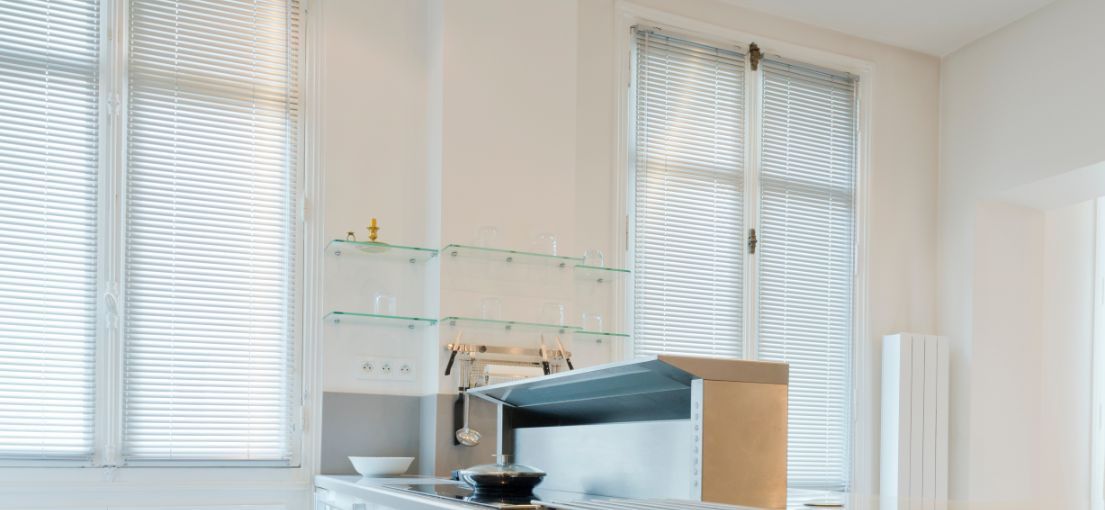 Kitchen interior with stylish aluminum blinds for natural light control