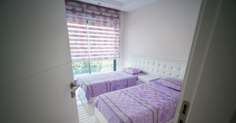 Bedroom with colorful layered window shades