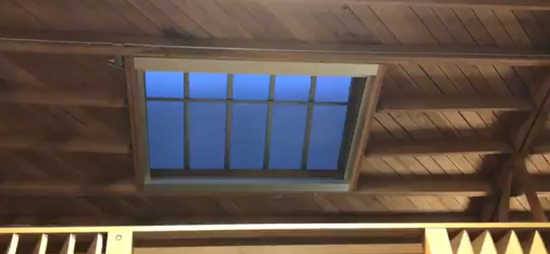 Wide view of automated skylight shades blending seamlessly with modern ceiling design