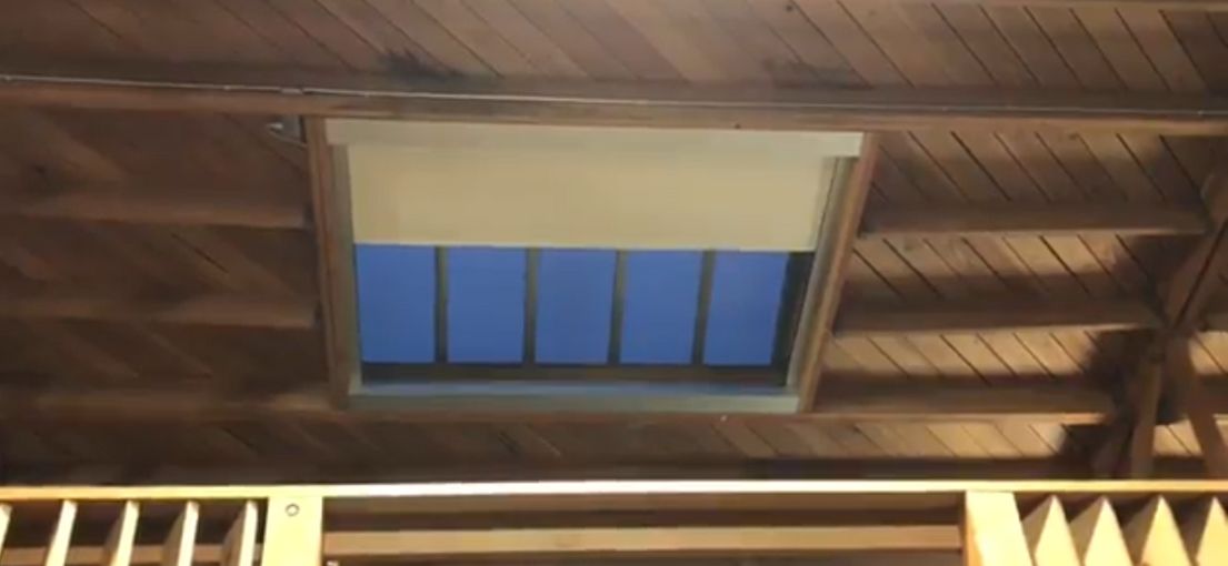Custom motorized roller shades installed by Master Blinds in guest house skylight