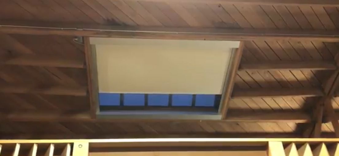 Remote-controlled skylight shade system in Venice guest house ceiling