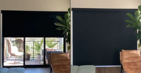 Motorized blackout roller shade descending over glass balcony door in Tarzana home