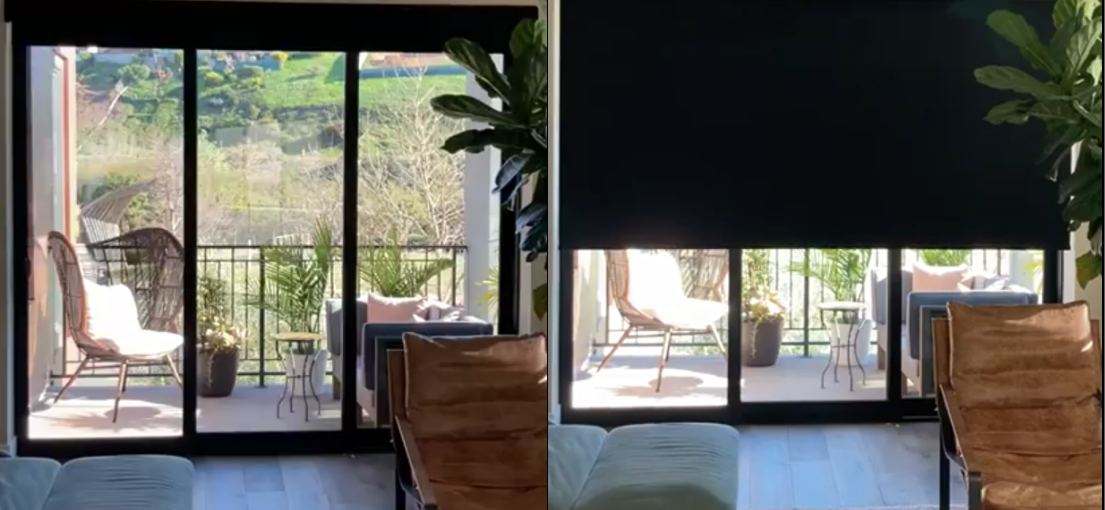 Wide view of automated blackout shades covering full-height glass doors