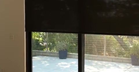 Custom automatic shades fitted by Master Blinds for Susan E. Cline’s bedroom.