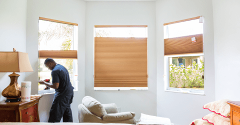 Perspective of a skilled male window blinds installer in action.