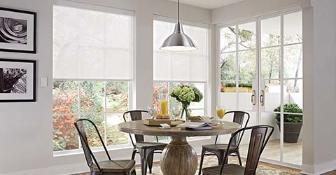 A view at a dining table protected with motorized coverings by Lutron