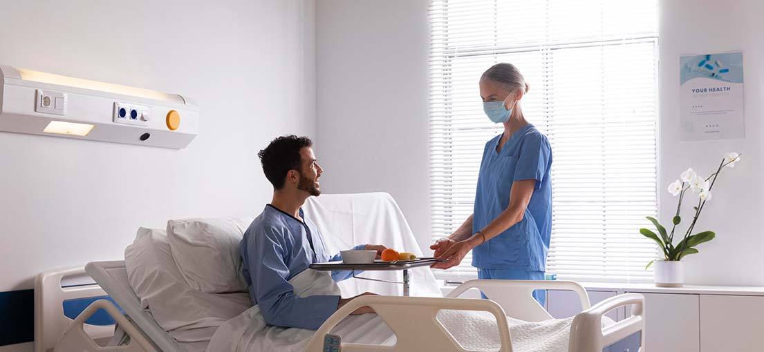 A patient talks to a nurse in recovery room