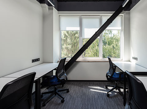 An architecture office space with blackout blinds on windows