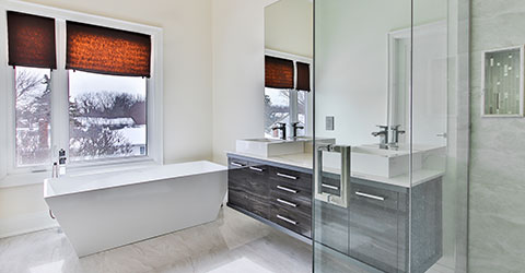 A modern bathroom with blackout blinds on the windows