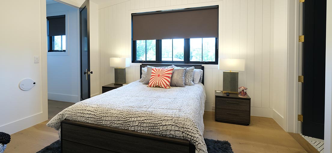 A view on a bedroom with brown blackout shades