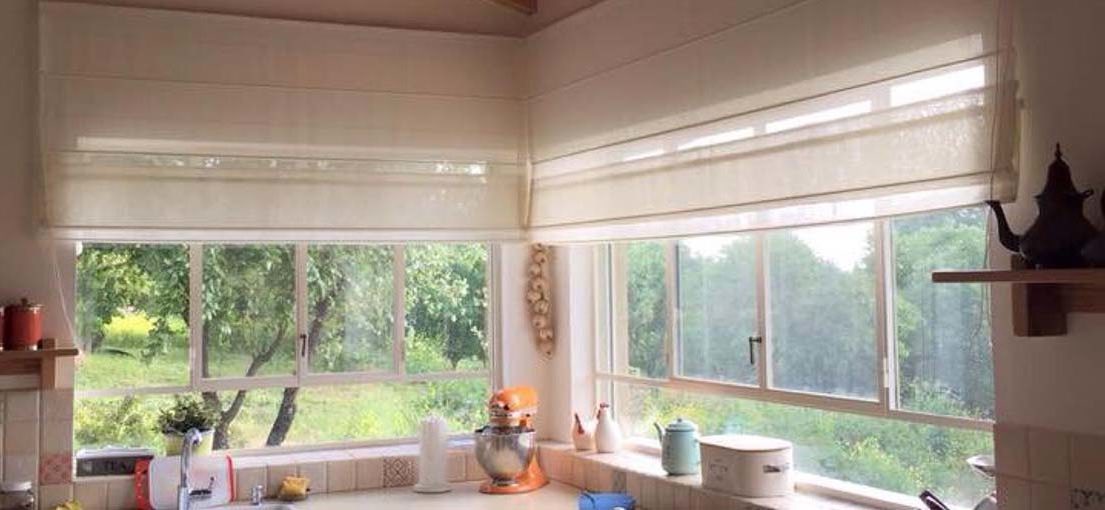 A close look at cordless Roman shades in on a kitchen window