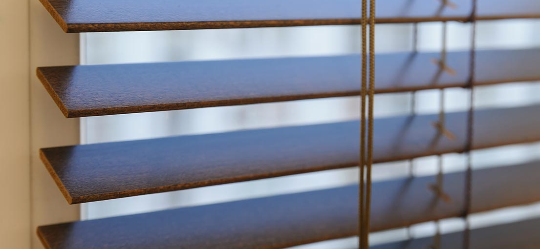 A close up view to the faux wood blind slats