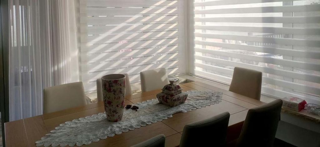 A view at layered shades in a dinning room