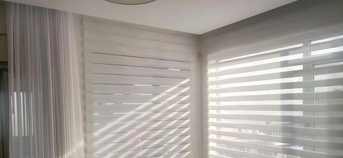A look at white layered shades on a glass door