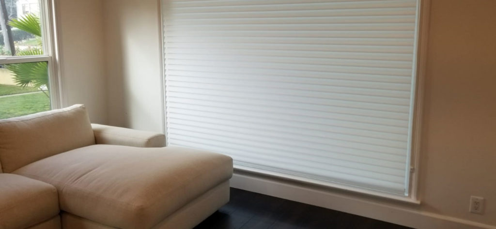 A view to motorized cellular shades in a living room