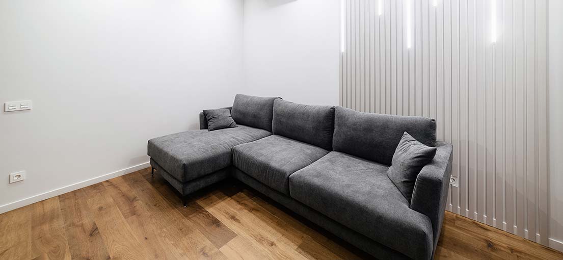 A look at grey sofa and white vertical blinds