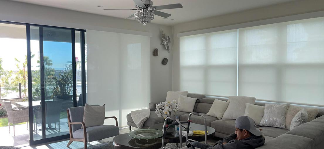 A view at a living room with motorized sheer roller shades
