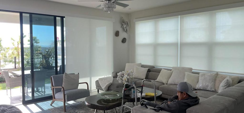 A view at a living room with motorized sheer roller shades