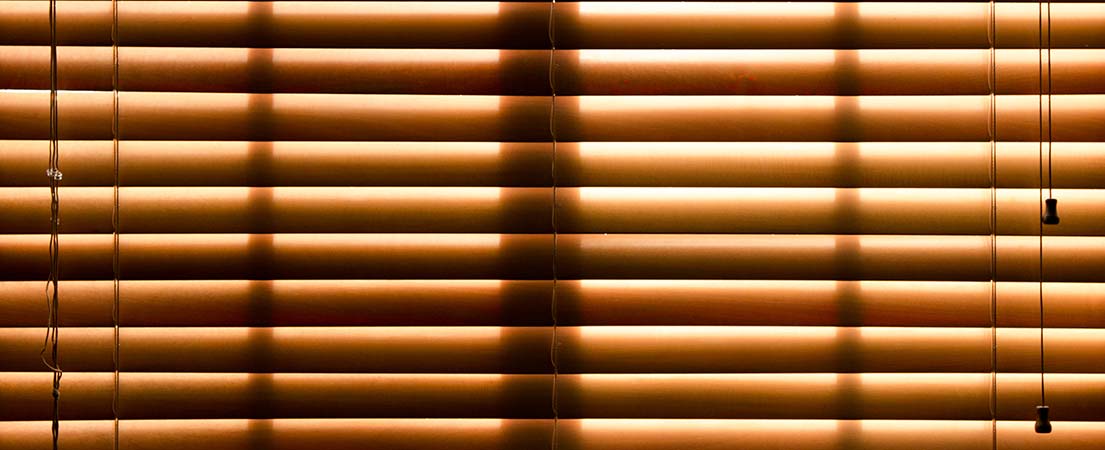 A close up to Venetian blinds with a manual cord