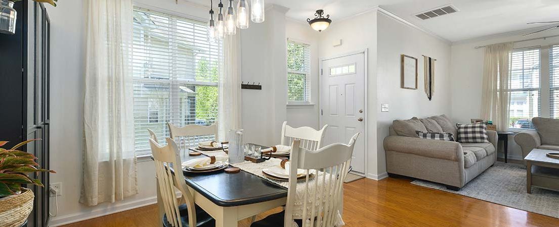 Living room with floor-to-ceiling blackout curtains in a neutral color.