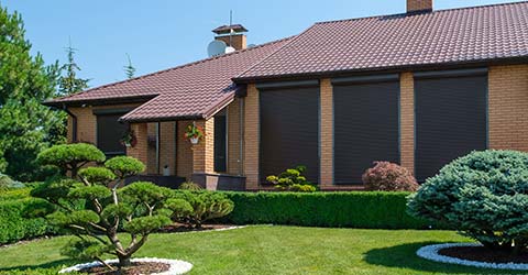 Exterior blinds providing shade and privacy for a home.