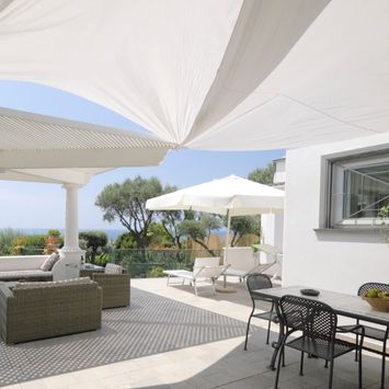 A view at a luxury patio covered with white shading system