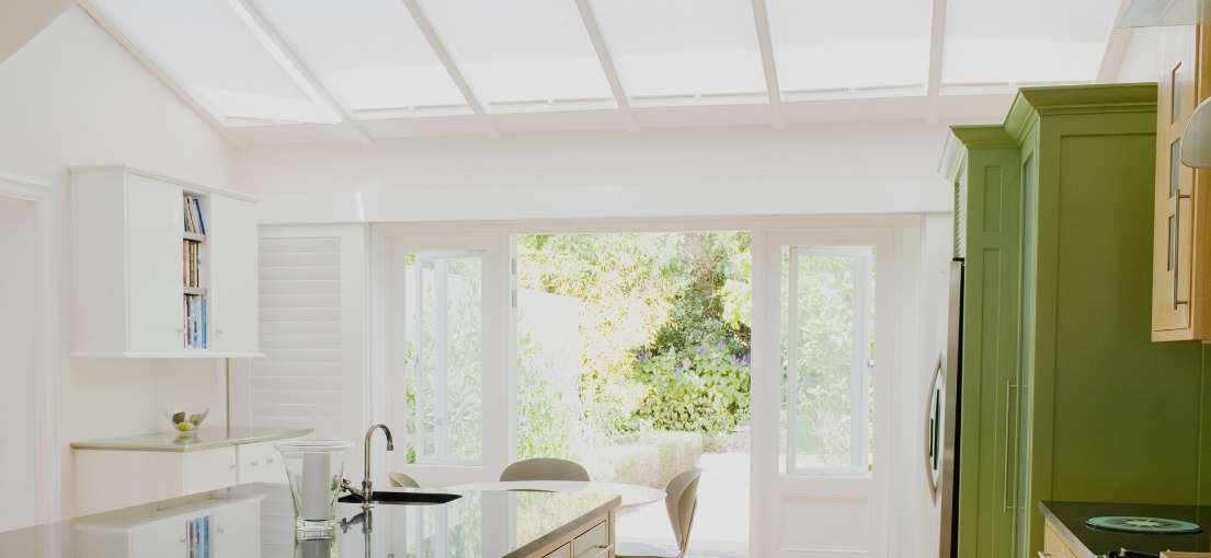 A view on a modern kitchen island under solar skylight shades
