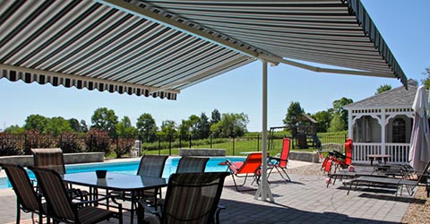 A view to a motorized awnings by a pool by Somfy