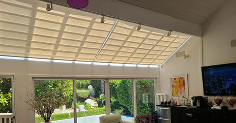 A view on a skylight shades in large living room space