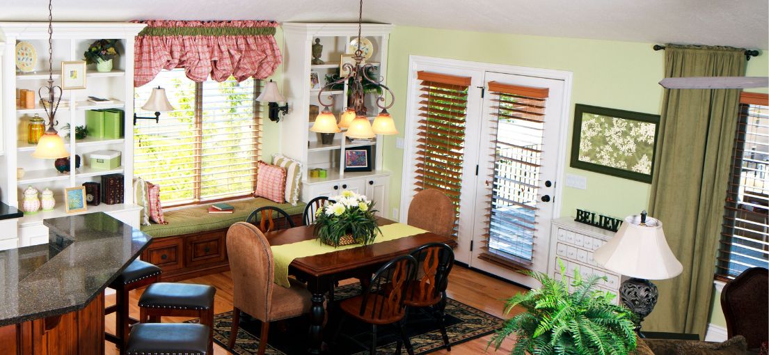Cozy dining area with faux wooden window blinds and valences
