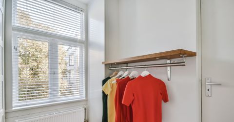 A view into closet room with aluminum blinds