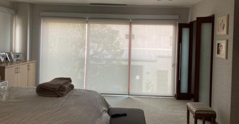 Spacious master bedroom with motorized shading system