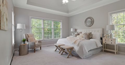 Spacious master bedroom with vinyl window blinds installed