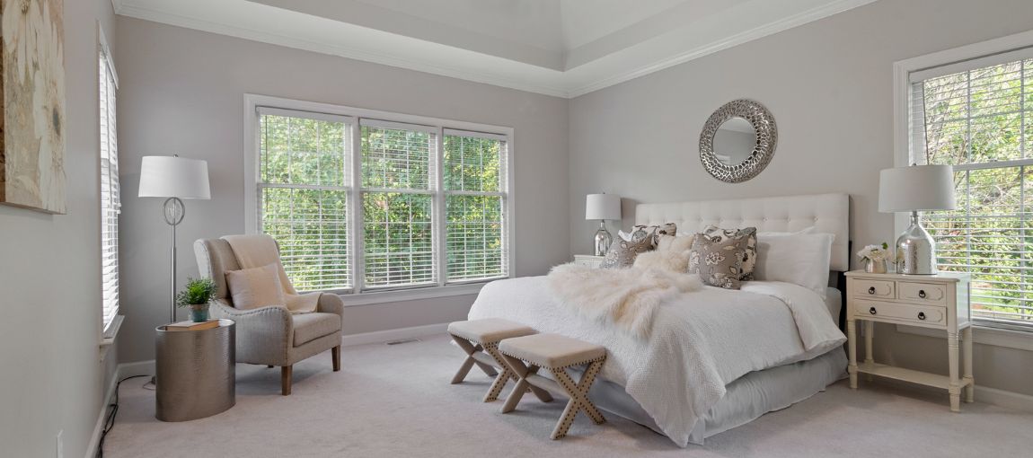 Spacious master bedroom with vinyl window blinds installed