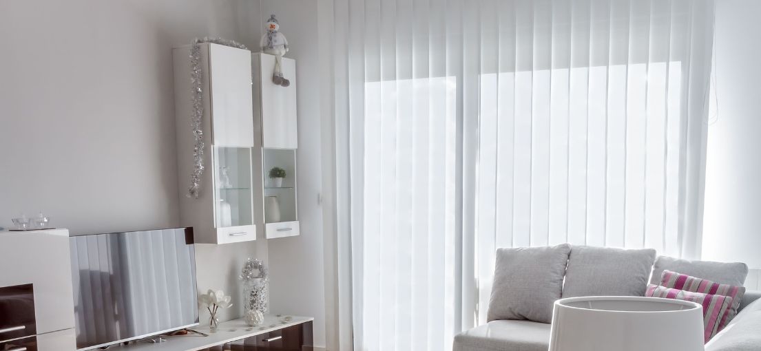 A view on a vertical window blinds in a spacious living room