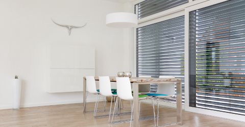 Large dinging room with aluminum blinds for windows