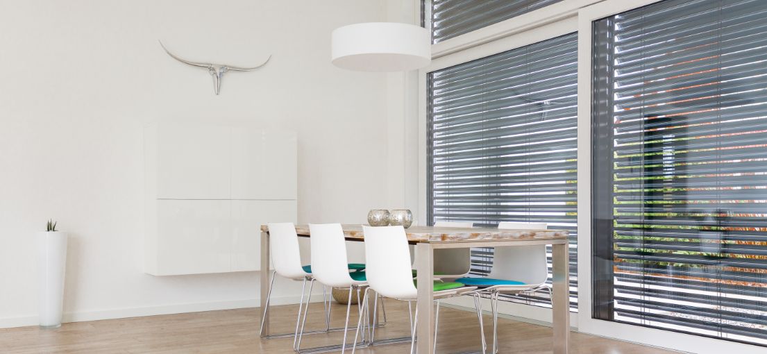 Large dinging room with aluminum blinds for windows