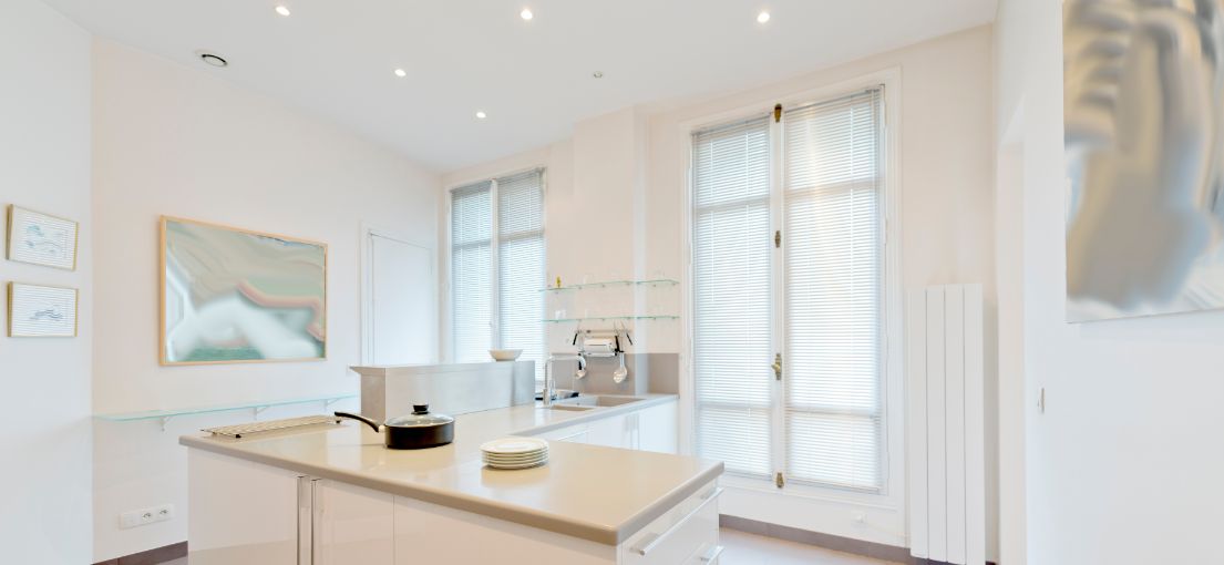 Bright, modern kitchen featuring aluminum window blinds