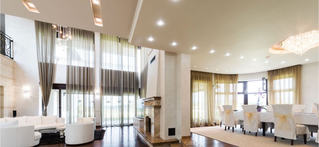 Luxury dining and living area with motorized custom curtains