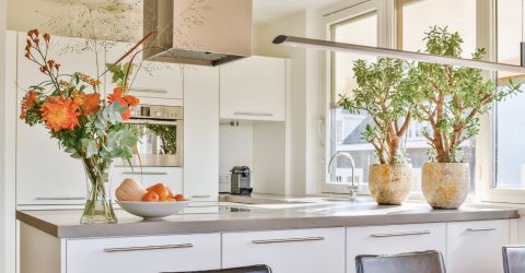Bright and modern Culver City kitchen with custom roller shades by Master Blinds, enhancing aesthetics and functionality.