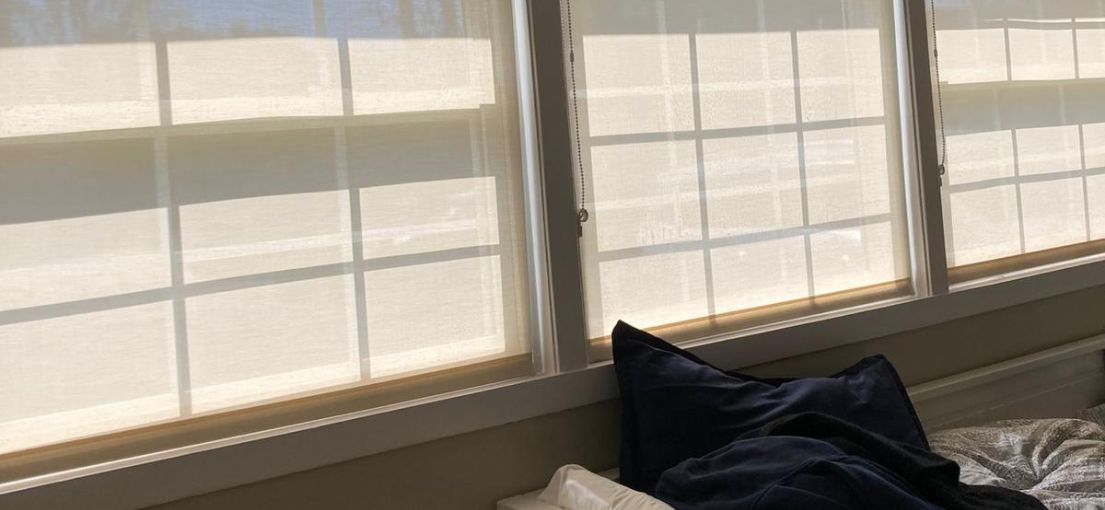 Serenely Styled Bedroom with Master Blinds' Roller Shades